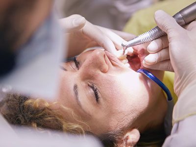 Dentist examining a patient’s gums during a periodontal check-up at C.Metric in Dbayeh